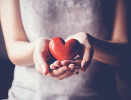 woman holding a heart shape in her hand