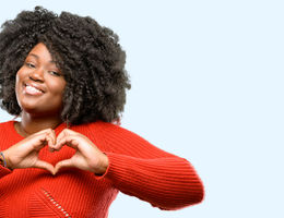 women creating a heart with her hands