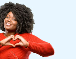 women creating a heart with her hands