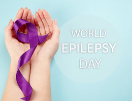 hands with purple ribbon honor world epilepsy awareness day