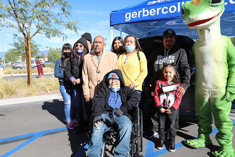 patient in wheelchair with his family