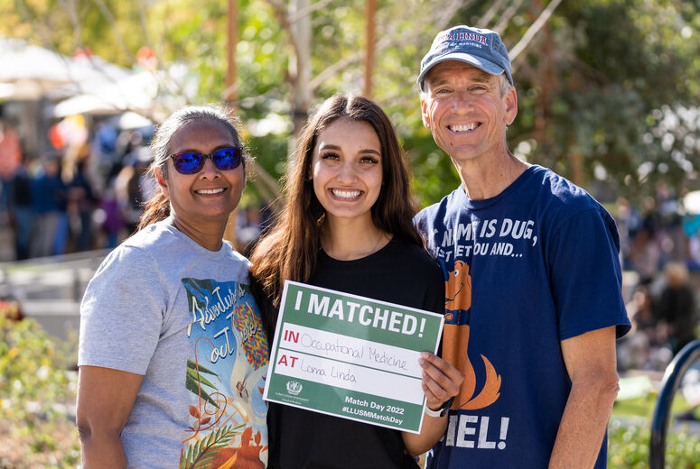 Two ladies and a man, smiling