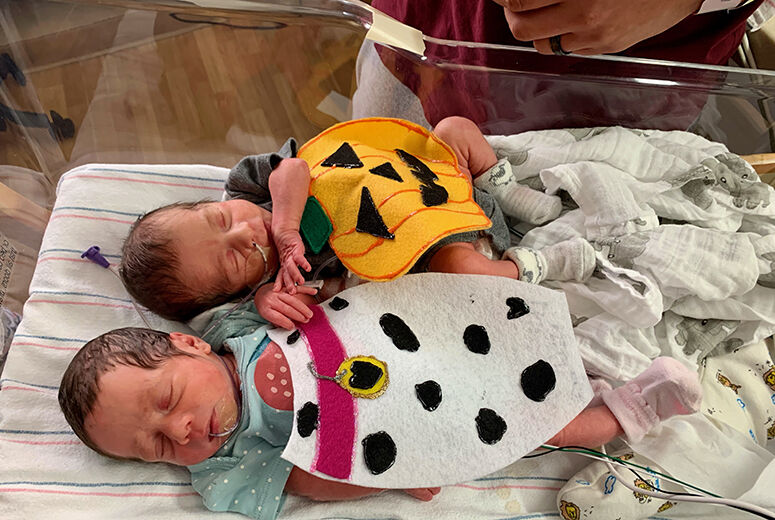 twin babies in costumes