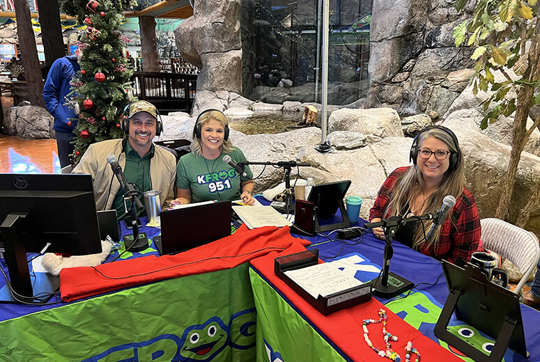 three people in KFROG booth