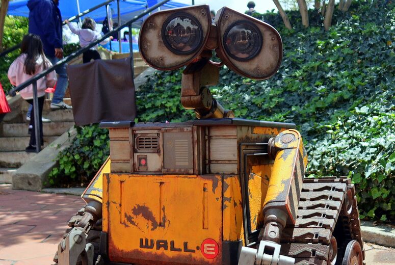 A life-size robot character stands on a walkway surrounded by event guests.