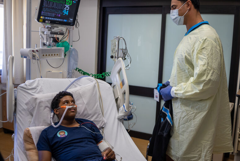 Jaelan hands out jersey to young patient