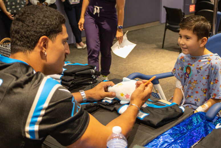 Phillips signs young patient's stuffed animal 