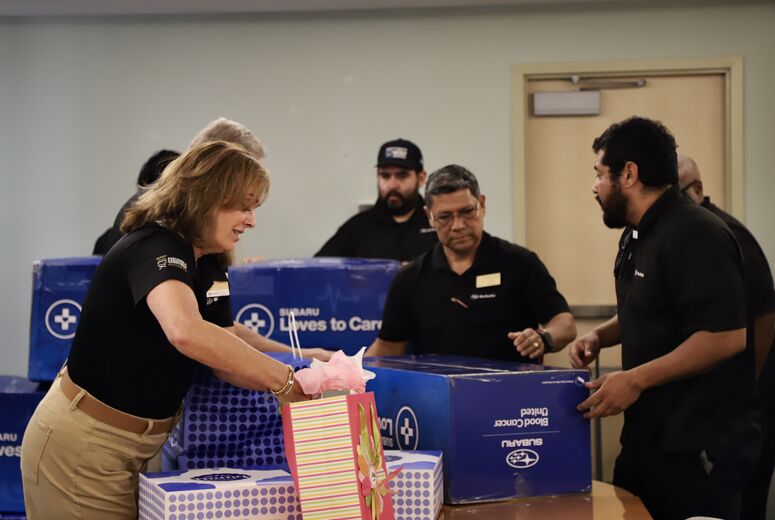 a group of people emptying boxes