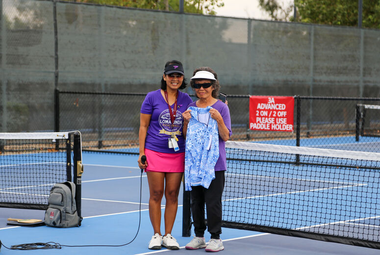 Kimberly Knowlton presents shirt to family friend