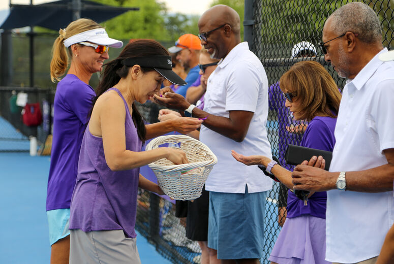 Attendees receive purple ribbons and charms in honor of Medina