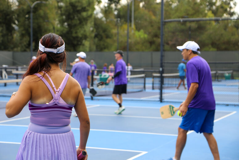 2 players engage in a game of pickleball