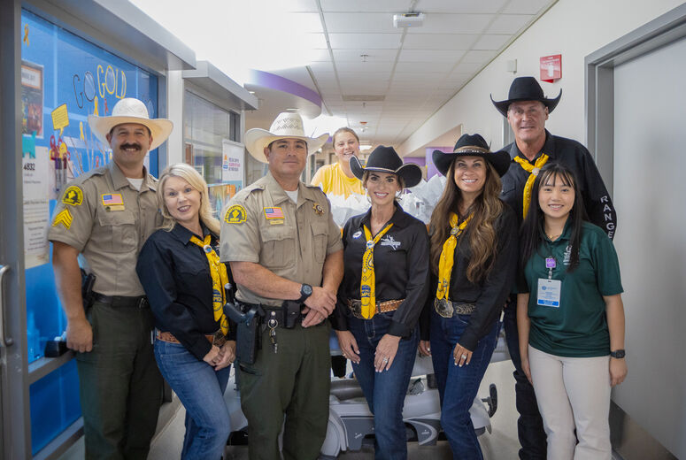 sheriff's deputies pose for photo in children's hospital hallway