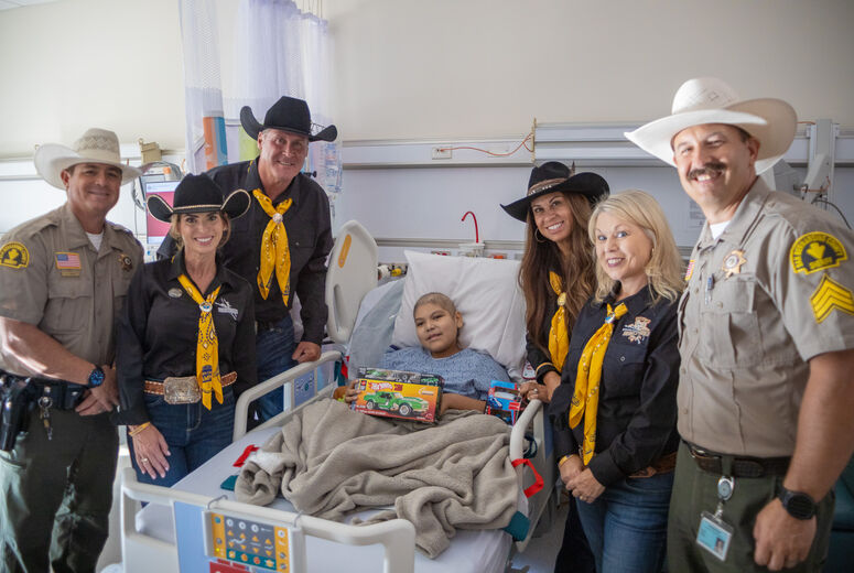 sheriff's deputies pose for photo with sick patient