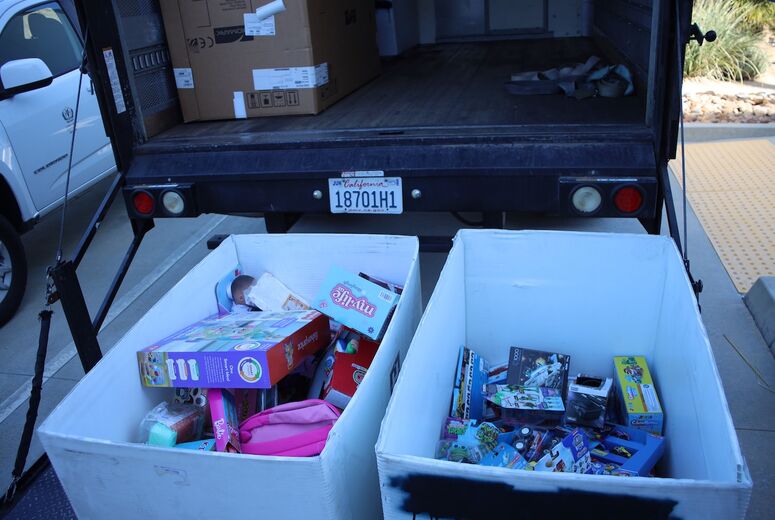 bins of toys being loaded into box truck