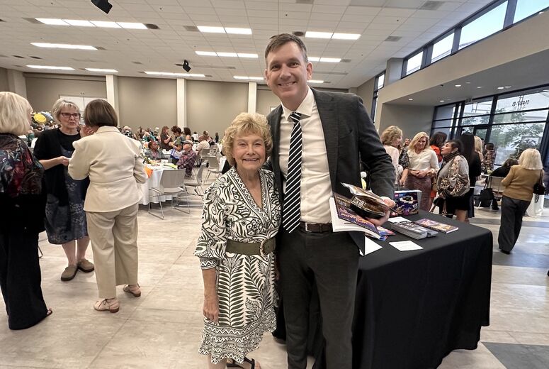 Children's Hospital administrator poses with event attendee