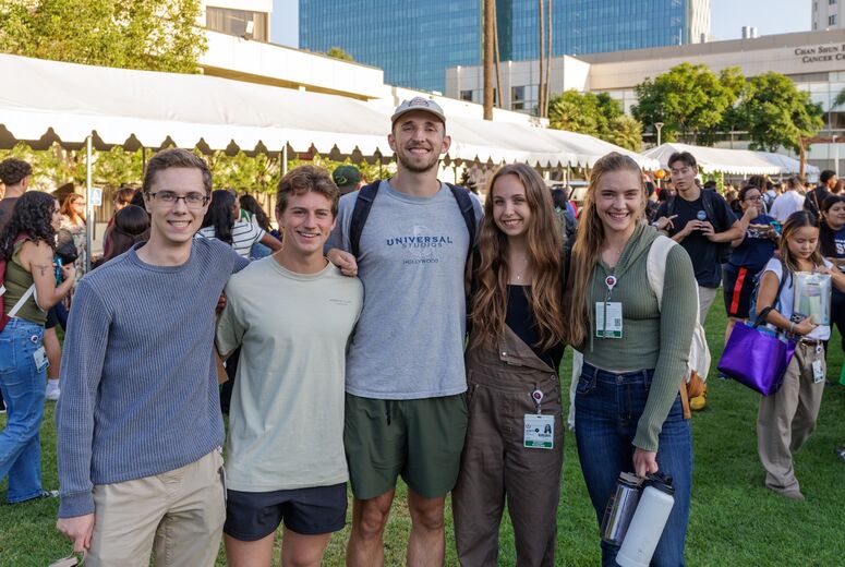 five students smiling at welcome back bash