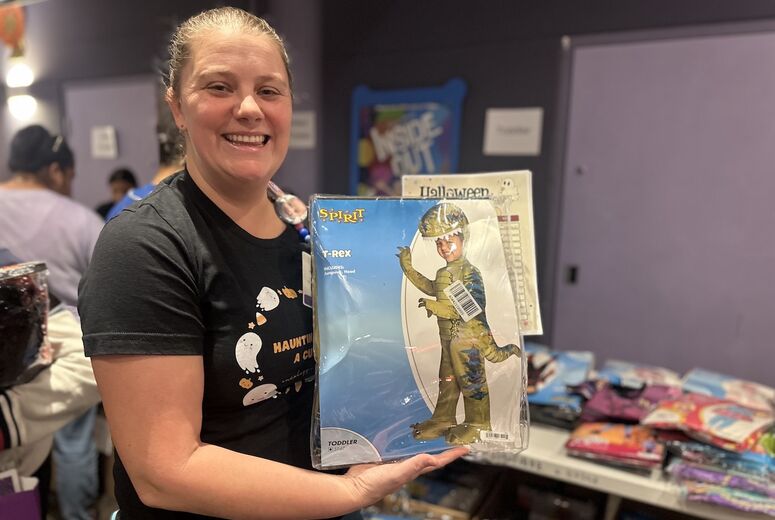 Child Life Specialist holds up costume