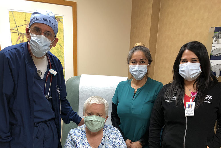 Catinean surrounded by her LLU cancer care team