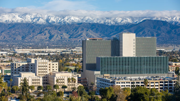 scenic view of hospital and snow-capped mountains in background