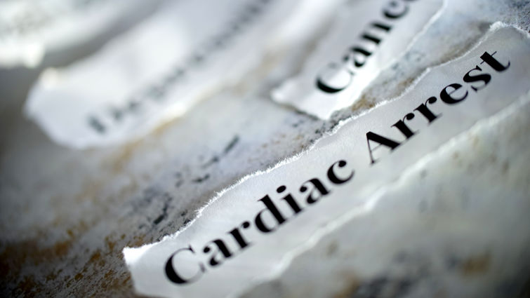 Pieces of paper on the table that say cardiac arrest and cancer