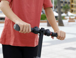 Hands on handlebar of scooter, close-up