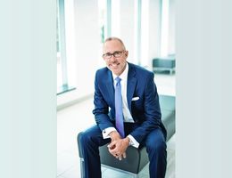 Caucasian man in business suit sitting in a hospital lobby