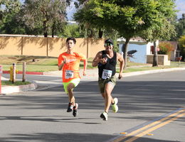 Two men running to the finish line at the Stand Up to Stigma 5K