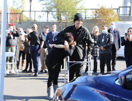 mother and son seeing new car for first time, smiling and emotional