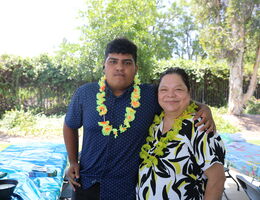 Son and his mother standing together to pose for camera