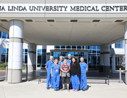 Dr. Parekh, Rickey Rodroguez, and the TARV team standing outside the Loma Linda Medical Center Murrieta