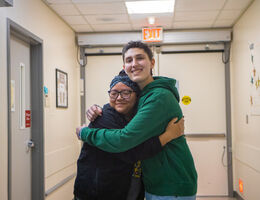 pediatric cancer patient hugs member of nursing staff