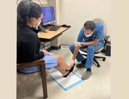 Dr. Mohammed Reza Amini consults a patient about her chronic venous insufficiency