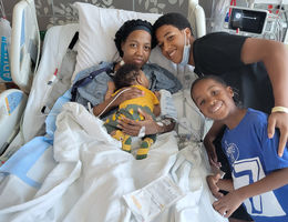 LaCresha Bell at Loma Linda University Medical Center, surrounded by family (her two sons and younger brother).