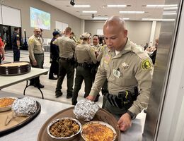 Sheriif's deputy serving food at event