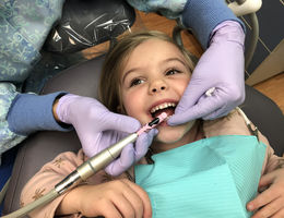 Young girl in dental chair getting dental examination