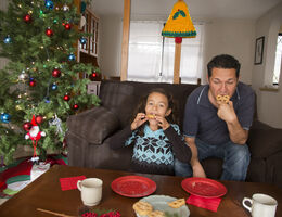 Father and daughter, taking Christmas snack 