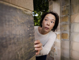 Woman peeking around corner