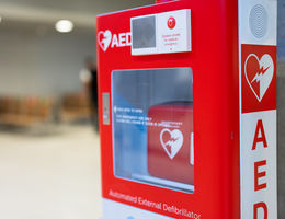 An Automated External Defibrillator, (AED) placed on the wall in public locations.