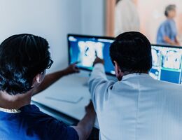 Doctors analyzing tomography medical x-ray at hospital
