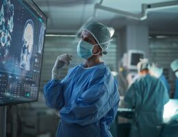 Professional Focused Caucasian Female Surgeon Reviewing Patient's Brain Scans