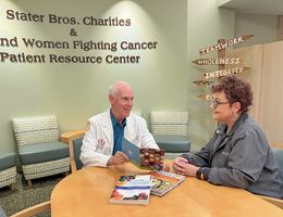 Andrew Woodward, MS, RD, CSO, an oncology nutritionist at Loma Linda University Cancer Center, speaks with a cancer survivor in the patient resource center.