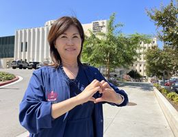 Zoe Lee, a registered nurse at Loma Linda University Health, shares her experience with atrial fibrillation to spread awareness of the condition. Zoe Lee makes a heart with her hands on Loma Linda University Health Campus