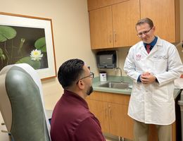 Medical oncologist Joel Brothers, MD, in his clinic at Loma Linda University Cancer Center where he consults with patients with prostate cancer about various treatment options.  