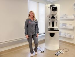 Heather Underwood, a mammography technician, stands next to a mammography machine at LLUH Women's Imaging Center.