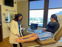 Pooja Swamy, MD, an interventional cardiologist and vascular specialist at Loma Linda University International Heart Institute, performs a vascular ultrasound on a woman’s leg.