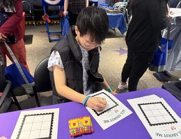 Young male patient sits and fills out worksheet at table