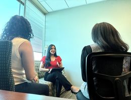 three people sit in a therapy session
