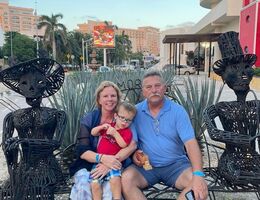 family sitting on a bench during vacation