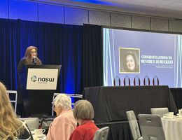 Dr. Buckles standing at podium