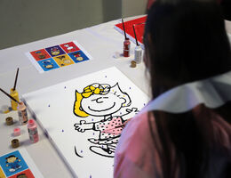 Girl painting mural of Sally Brown